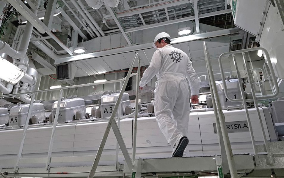 Crew member in MSC uniform inspecting the ship's engine room | MSC Cruises Crew member in MSC uniform inspecting the ship's engine room | MSC Cruises