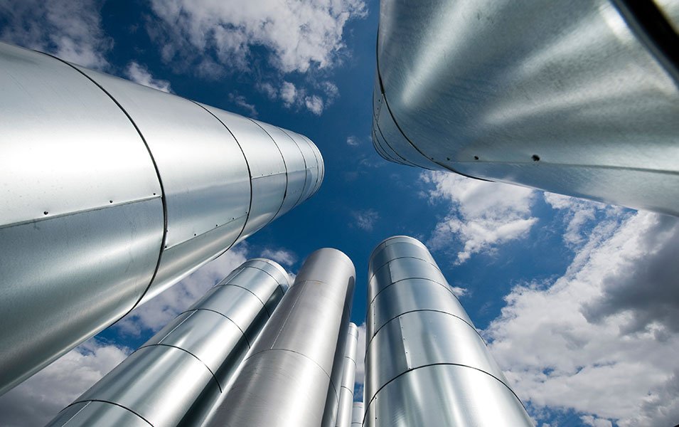 Silver metallic chimneys against a blue sky with clouds | MSC Cruises Silver metallic chimneys against a blue sky with clouds | MSC Cruises
