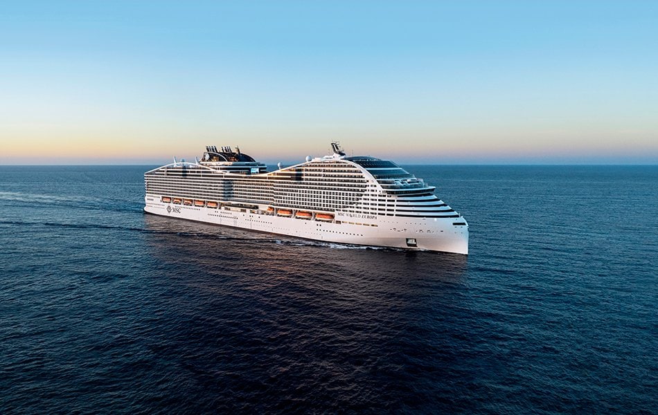 MSC World Europa cruise ship sailing on open sea at sunset | MSC Cruises MSC World Europa cruise ship sailing on open sea at sunset | MSC Cruises