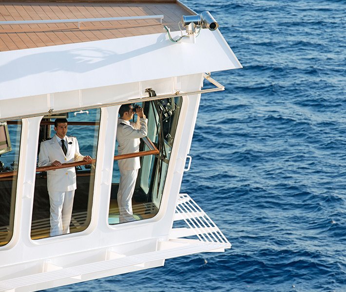 Ship officers in the bridge overlooking the ocean | MSC Cruises