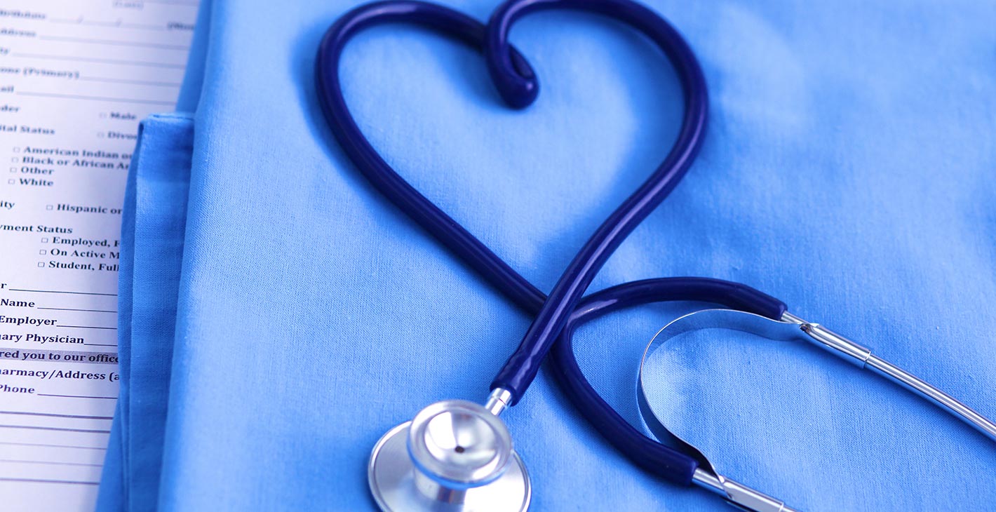 A stethoscope forming a heart shape on a blue cloth, symbolizing health services onboard | MSC Cruises