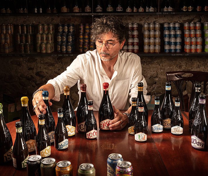 A variety of craft beer bottles displayed on a table in a cozy setting | MSC Cruises