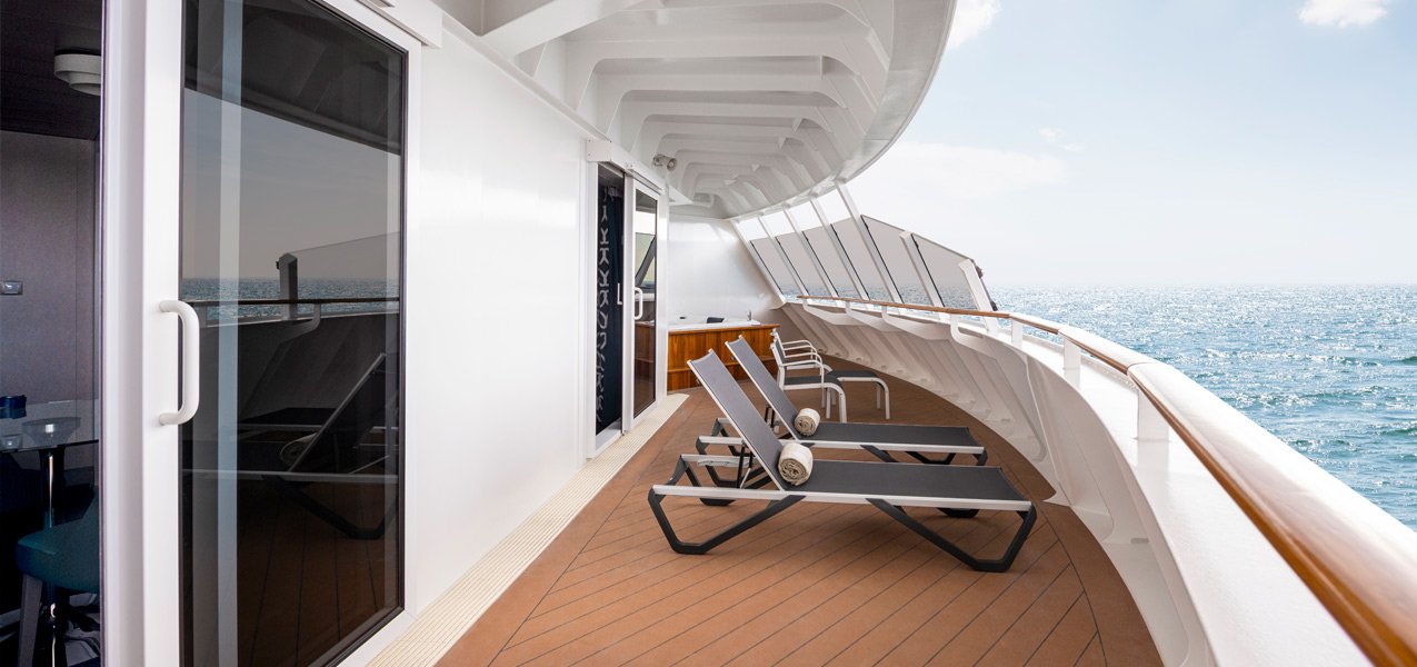 Spacious private balcony with lounge chairs overlooking the ocean | MSC Cruises Spacious private balcony with lounge chairs overlooking the ocean | MSC Cruises