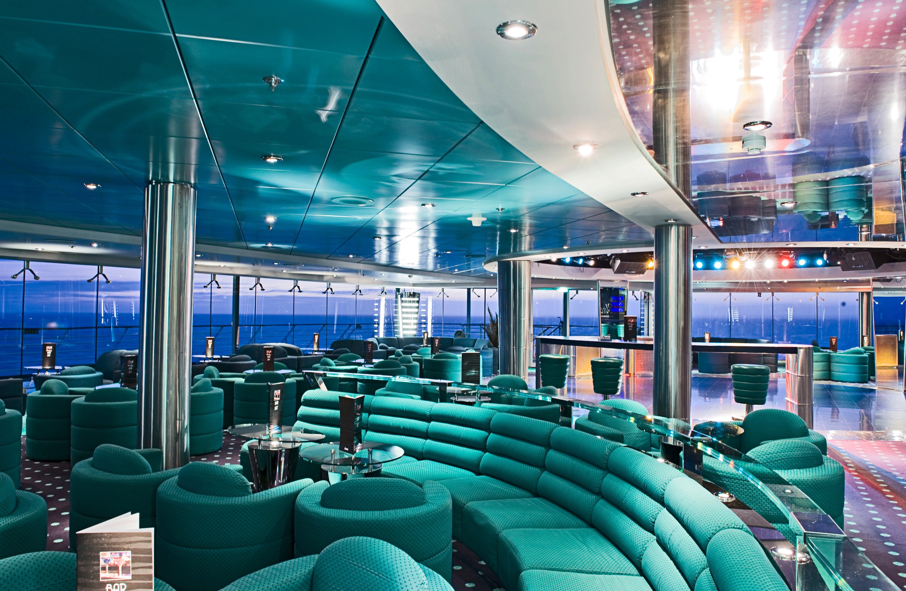 Elegant lounge with panoramic ocean views and modern seating on an MSC cruise ship | MSC Cruises
